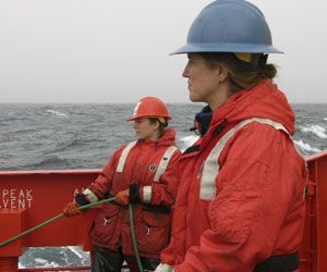 In rough seas, Brenna McLeod (left) and Kelly Rakow hold lines attached to the MOCNESS net. 