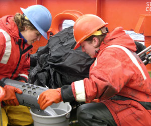 Kelly (left) and Brenna empty one of nine plankton samples into a bucket. 