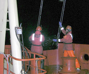 Byron Pedler (right) reaches for the net�s frame as it is pulled over the stern.  