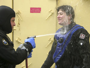 Divers team up to rinse off in fresh water as soon as they return to the ship, to keep salt water from damaging the suits and gear. Erich Horgan (left) enthusiastically assists Diane DiMassa