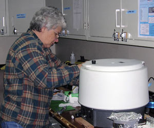 Izzie Williams, at the fluorometer, takes measurements of the amount of plant pigment in salp stomachs. (Photo by D. DiMassa, Massachusetts Maritime Academy) 