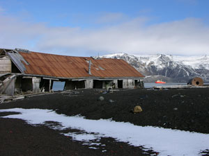 Decaying barracks for scientists at a former British research station on Deception Island, with the Gould in the background. (Photo by Larry Madin, WHOI)