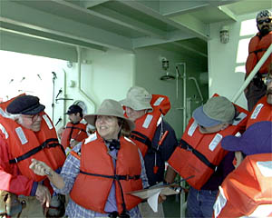 Mitzi Crane, the 1st Mate, directs the science party during the fire and boat drill. 