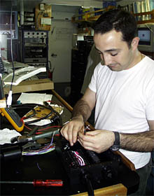 Anthony Tarantino connects wires in one of the junction boxes used on Alvin. 