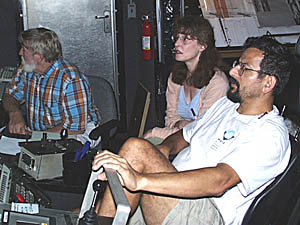 The last watch in the Control Van for the Argo II lowering we finished this morning. Rob Palomares (right) “flies” Argo II about 8 meters above the seafloor. Rachel Haymon, the watch leader, watches the video monitors closely so that she doesn't miss any important lava contacts. Tom Crook makes sure that the navigation fixes from the acoustic transponders are good so that we know exactly which piece of the seafloor Argo II is “seeing”. 