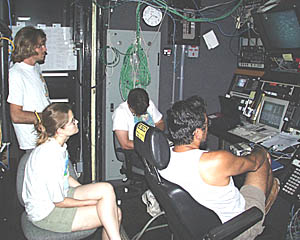 When Argo II is traversing the seafloor, everyone gets to see what no person has seen before -- the bottom of the ocean in this part of the Galapagos Rift valley. From left: Kate Gans, Greg Kurras, Dan Scheirer, and Rob Palomares, who is flying Argo II using the winch controls.