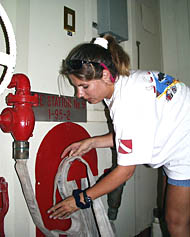 Anja is responsible for checking the safety and readiness of the emergency equipment on board R/V Melville. Here, she checks the firehoses in the Main Lab.