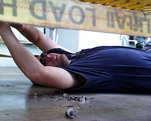DSOG tech Pete Collins crawls under the base of the new elevator to attach a sample box.  