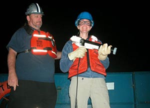 Shipboard Scientific Services Group Technician Dave Sims and scientist Selene Eltgroth shoot the XBT, or expendable bathythermograph, into the dark of last night’s ocean. The XBT has a temperature sensor attached to a 760-meter wire that sends the information back to R/V Atlantis.