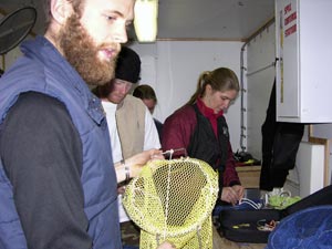 From left, Byron Pedler, Jeff Mercer, Kerri Scolardi, and Kelly Rakow assemble collecting bags and gear for a dive, in the small metal dive van. (Photo K. Madin, WHOI) 