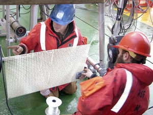Erich Horgan (left) and Byron Pedler check the setting and calibration of the LAPIS lighting system. (Photo by Larry Madin, WHOI) 