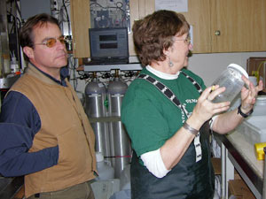 3:30 a.m.: In the wet lab there are jars of fresh salps to “log.” Pat Kremer looks in each jar and calls out to Larry what’s in it, who records the contents of each jar, and the time and depth it was caught. Pat then hands out the salps to researchers. (Photo by Kate Madin, WHOI)