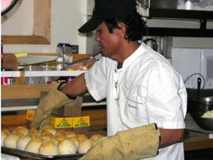 Steward Romeo Agonias bakes golden rolls for Monday’s lunch.