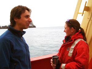 Brennan Phillips, graduate student at the University of Connecticut, and Kerri Scolardi, a marine biologist at Mote Marine Laboratory, watch as the L. M. Gould moves through Neptune’s Bellows into Deception Island’s lagoon. (Photo by Kelly Rakow, Woods Hole Oceanographic Institution)