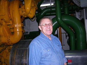 Paul Waters explains the color-coded fuel and seawater lines in the engine room of the Gould.
