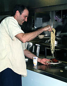 Phil Forte has second helpings of pasta at dinner. 