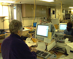 Dan Fornari and Danielle Fino work on the Dive and Discover website on computers in the Main Lab on R/V Atlantis. 