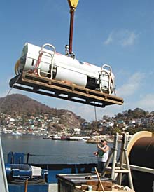 The DSL-120 sonar is lifted from a van onto the ship’s fantail. 