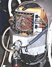 The nosecone of the DSL-120 sonar showing the junction box where all the electrical wires that go to different parts of the vehicle come together. The red cable at the bottom is where the front of the sonar fish is joined to the fiber optic cable that goes to the ship. The light brown blocks inside the vehicle are syntactic foam, a special material that provides flotation for the vehicle.