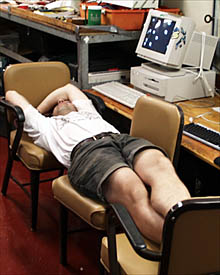 Craig Elder catching a cat-nap on some chairs in the Main Lab after being up all night fixing the DSL-120 sonar system.
