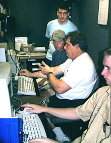 Steve Gegg (center) training the first three scientists to stand watch with other members of the Deep Submergence Lab team in the Control Van. The scientists’ job is to keep track of where the DSL-120 is surveying and make sure that the data are being collected and recorded properly. Dan Scheirer is standing, Tim Haskell is in the background, and Tim Head is in the foreground. 