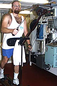 Scott White does his morning workout in the exercise room using the ski-machine.
