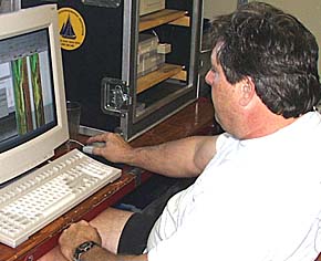 Steve Gegg processing the sonar data on his computer. Steve plays a key role in the data gathering operation for the DSL-120 sonar and in teaching scientists on board how to process the records to make the best possible images of the volcanic features on the seafloor.