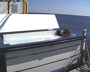 Captain Eric Buck relaxes in Melville’s hot-tub/pool on the 01 deck after his bridge watch this morning. The tub was built by Dave Grimes, Paul Bueren, and Dave Murline, who are all members of Melville’s crew. The pool is filled with seawater and is occasionally used for other swimmers (see next slide!). 