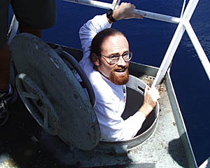Scott White emerges from the hatch that opens out to the small platform in the Crows Nest. 