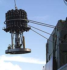 The CTD (temperature, conductivity, depth) rosette sampling system being lowered over the starboard rail of R/V Melville. The long gray cylinders on top are the Niskin sampling bottles that we use to collect water. Each bottle has a volume of 2.5 liters. The metal cylinders below the bottles are the pressure cases for the various sensors. All the signals from the CTD are transmitted up the coaxial cable and into the computer that Rob Palomares operates during the lowering. Rob can trigger each bottle so that it closes and captures a sample. We took samples very close to the seafloor, about 5 meters above the diffuse flow hydrothermal field that we observed with Argo II, and then at selected depths up to 300 meters above. 