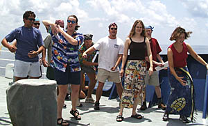 The Pollywogs provide entertainment for King Neptune and His Royal Court -- a requirement of the Equator Crossing ceremonies. The Pollywogs performed a song and dance that they created about the rigors of life at sea on the Melville. (From left: John Burgess, Tim Head, Tim Haskell (partially seen), Julia Getsiv, Ben Wigham, Erin Todd, Kate Gans, Peter Lean, and Clare Williams).