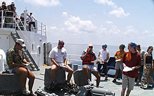 The Pollywogs perform for the Royal Court and other Noble Shellbacks watching from the deck above on R/V Melville.