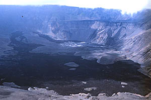 A photograph taken in 1997 inside the caldera of La Cumbre volcano on Fernandina Island. The dark lava flow in the foreground is probably the 1988 eruption. The view is looking towards the southeast. (Photo by Dr. Mark Kurz - WHOI).