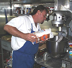 Dan Engelbrecht pours flour into the industrial mixer to make fresh bread. Making fresh baked goods on board is one of the trademarks of a great shipboard cook. Dan and George tempt the scientists and crew each day by making a selection of rolls, breads, pizza, cakes, muffins, and cookies. 