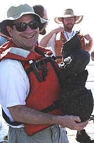 Mark Kurz, of Woods Hole Oceanographic Institution, is a scientific collaborator for the short, 3-day mapping and sampling program we conducted off Fernandina Island. Here, Mark shows off one of the “toothpaste squeeze-out” samples that we dredged from the NW Rift zone of Fernandina. One of the interesting things about this rock is that it has many olivine crystals in it, while the lava samples on the island have very few olivine crystals. Mark, Mike Perfit, and Dennis Geist of the University of Idaho will be studying the geochemistry of the lava samples we recovered from the submarine rift zones of Fernandina. 