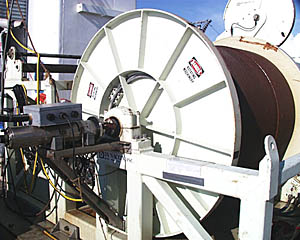 The “traction winch” is a key part of the towed mapping systems we are using on this expedition. The drum of the winch has 11,000 meters of fiber optic cable wound around it. This cable sends electricity and control signals down to the DSL-120 sonar or Argo II vehicles. The data from the vehicles come back up the cable. The electrical and optical signals must pass through the entire length of cable without picking up any “noise”. An important connection is between the end of the cable on the drum and the transmission line that transmits the signals to and from the Control Van on the ship. Special devices called “slip rings” (see next photo) are used to transmit this signal through this connection as the drum rotates. The “slip rings” must work perfectly at all times.