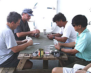 A tradition on R/V Melville among some of the crew members is to play cards after dinner. Here (from left), Dennis Barclay, Rick Koppel, Reynaldo Esteban, and John Baon relax with a few hands of cards.