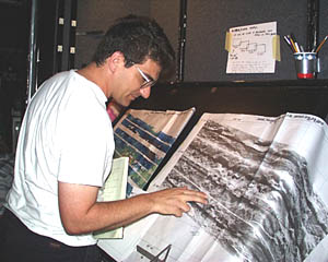 Dan Scheirer has been the watch leader for the 12-4 watch team since Rachel Haymon disembarked in the Galapagos. Here, he is checking the navigation plot to see where Argo II is traversing the seafloor. We have been plotting all of our tracks over large-scale maps that Dan has made from the DSL-120 sonar data.