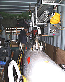 PJ Bernard tightens up one of the lines that keeps the DSL-120 sonar fish secured in the shipping van. In a few days, this van will be completely filled with equipment and samples that will be shipped back to Woods Hole Oceanographic Institution.