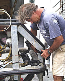 PJ Bernard takes the equipment and cables off the Argo II frame in preparation for shipping. Most of the electronics and sensors are shared between Argo and the remotely operated vehicle (ROV) Jason. This summer, the ROV Jason will be used on the Juan de Fuca Ridge -- part of the global mid-ocean ridge off the coast of Washington state.