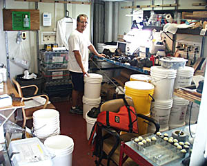 The rock preparation room is getting pretty crowded! Erin Todd barely has enough room to walk around as he samples and curates the basalts recovered in the last few dredge hauls. We have done 45 dredge hauls and 45 rock cores during this cruise, and have nearly 70 buckets of rocks to ship back home! The total weight of the rock samples to be shipped is over 1 ton! 