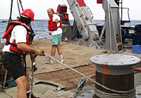 Ron directs all the deck operations to make sure they are done safely and efficiently. Here, he is giving instructions to Craig Elder during the recovery of Argo II. Craig is holding a line that is wrapped around the capstan and leads to Argo II. The line helps keep Argo II steady while it is lowered on to the deck. 
