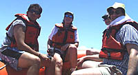 Julia (center) taking a spin in R/V Melville’s rescue boat with Jon Burgess (left), Maya Tolstoy (background right), and Dan Scheirer. 