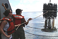 Julia tending the recovery line to the CTD rosette sampling system during its recovery. Rob Palomares, the CTD technician, is directing the operation and giving signals to the winch operator. 