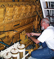 Chief Engineer Ron Wheatley checking one of R/V Melville’s main engines.