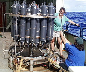 Shipboard techs Amy Simoneau and Dave Sims prepare the CTD, used to detect hydrothermal plumes, for tomorrow’s test dive.  