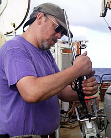 Chief pilot Will Sellers places a temperature probe in Jason’s manipulator to check its grip.  
