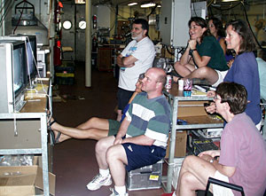 Scientists gather in Knorr’s main lab to watch the live video feeds from ROV Jason’s exploration, happening two and a half miles below the ship.  