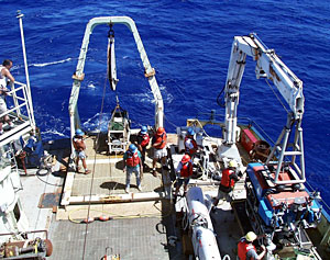 On Knorr’s fantail, crew members ready ROV Jason for the first launch of the expedition. Notice that everyone wears lifejackets and hard hats.  