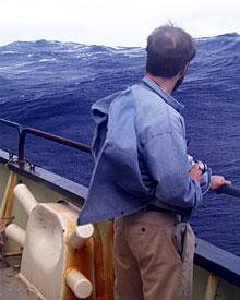Robert Kunzig watches the 15- to 18-foot waves roll against Knorr’s starboard side. 